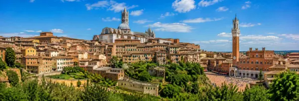 Siena, Italy historic cityscape with Siena Cathedral, Torre del Mangia and Piazza del Campo