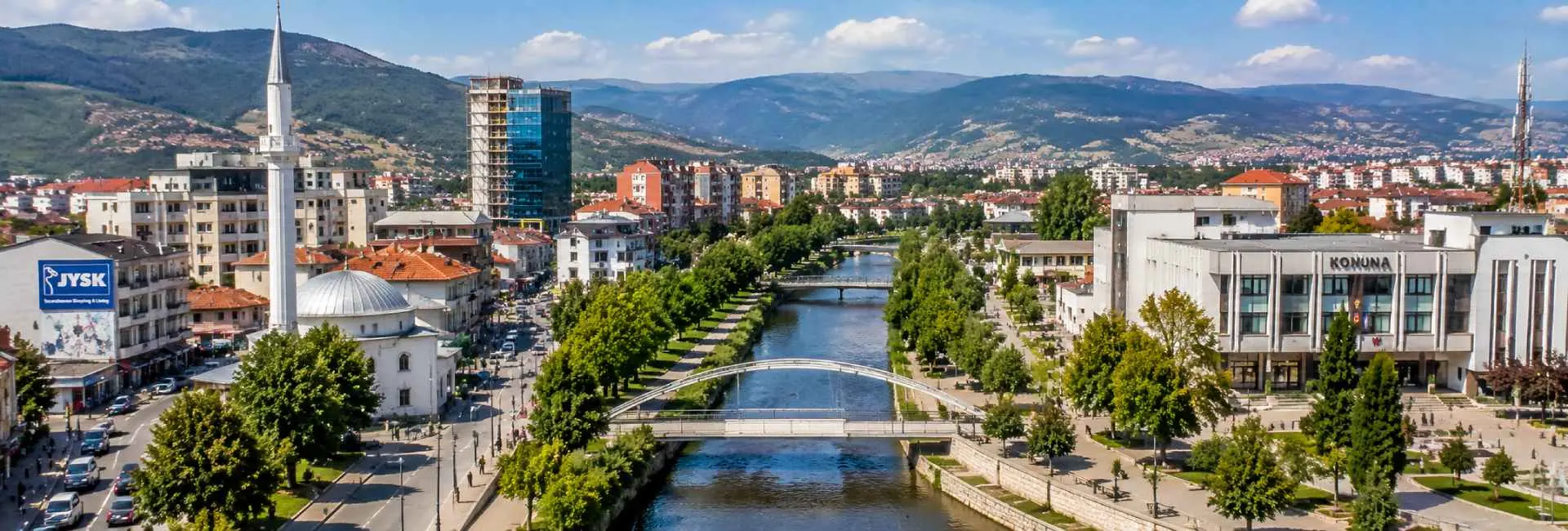 Panoramic view of Ferizaj, Kosovo, featuring the Great Mosque, city center and surrounding mountains