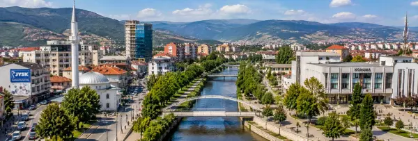 Panoramic view of Ferizaj, Kosovo, featuring the Great Mosque, city center and surrounding mountains