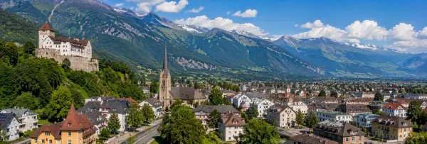 Panoramic view of Vaduz, Liechtenstein, with Vaduz Castle, historic town, and Alpine mountains