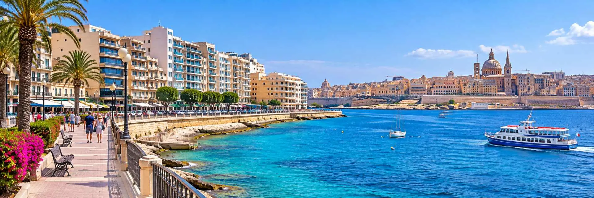 Sliema waterfront promenade with turquoise sea and Valletta skyline across the harbor in Malta