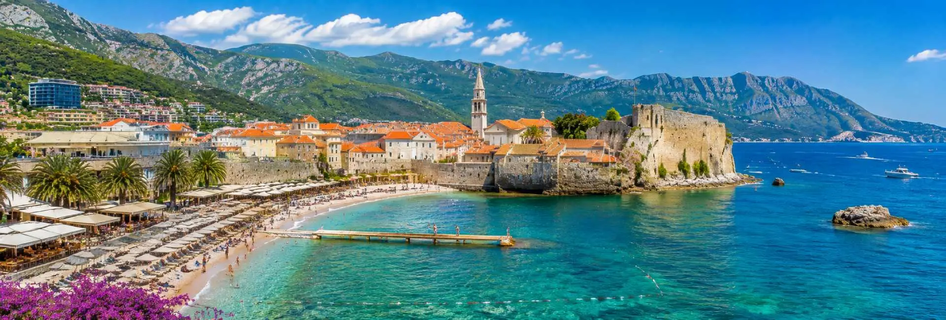 Budva Old Town and medieval Citadel beside the turquoise Adriatic Sea in Montenegro.