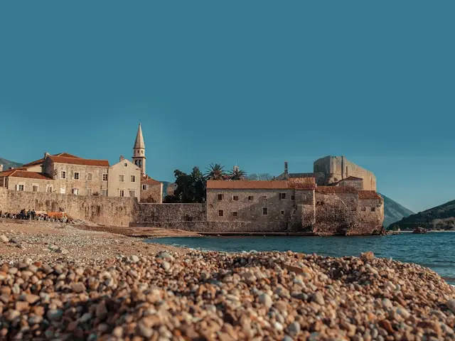 Budva Old Town waterfront with historic stone walls and red-roofed buildings in Montenegro