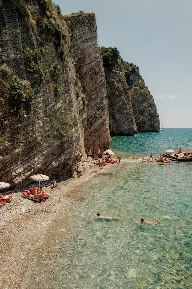 Mogren Beach in Budva, Montenegro, surrounded by dramatic coastal cliffs