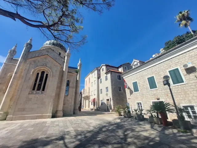 Historic stone church and old town street in Herceg Novi, Montenegro