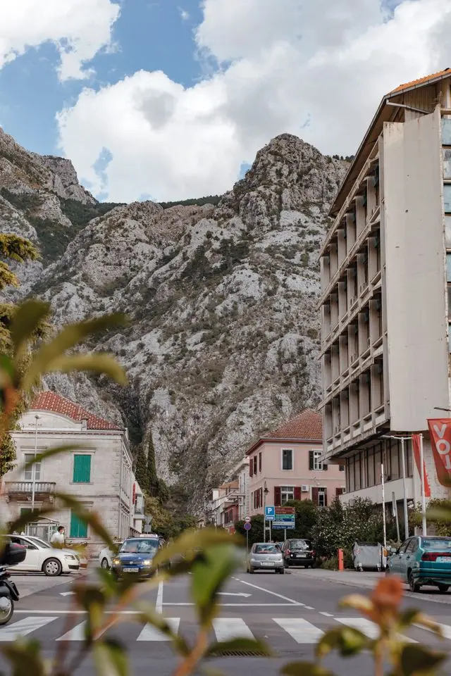 Street in Kotor, Montenegro, beneath dramatic limestone mountains