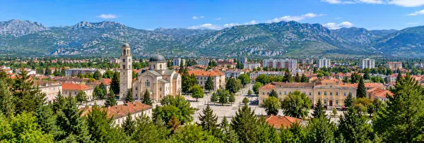 Panoramic view of Nikšić, Montenegro, with the historic center and rugged mountain backdrop.