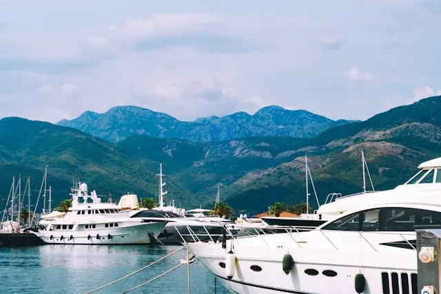Luxury yachts in Tivat marina with the mountains of Montenegro behind them