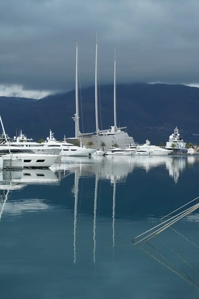 Luxury yachts at Porto Montenegro marina with mountains in the background