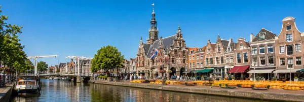 Alkmaar canal with historic buildings, cheese market and Waagtoren in the Netherlands