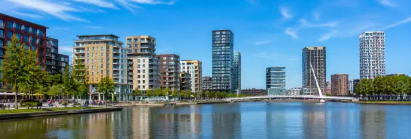 Almere, Netherlands waterfront skyline with modern buildings, Weerwater and a cable-stayed bridge