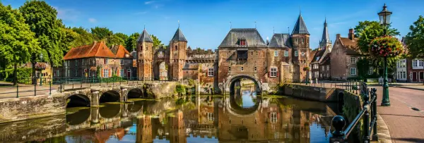 Koppelpoort and historic canal in Amersfoort, Netherlands, on a bright sunny day