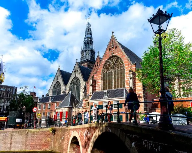 Oude Kerk church beside a canal in Amsterdam