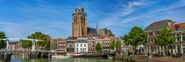 Dordrecht, Netherlands historic waterfront with canals, boats, and the Grote Kerk tower
