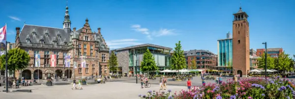 Enschede city center with historic architecture, modern buildings, and a lively pedestrian square