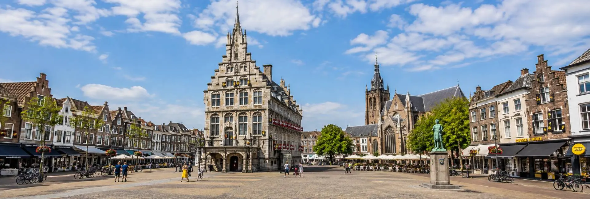 Gouda historic market square with the ornate old town hall and Gothic Sint-Janskerk in the Netherlands