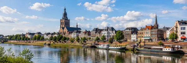 Roermond waterfront with historic buildings, boats and Munsterkerk in the Netherlands