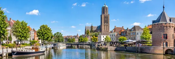 Zwolle, Netherlands, with its historic waterfront, boats, and distinctive church tower.