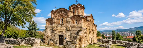 Historic Byzantine church in Kumanovo, North Macedonia, with intricate stonework, arches and surrounding ruins