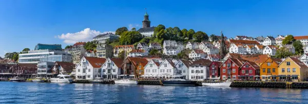 Stavanger, Norway waterfront with colorful wooden houses, harbor boats and historic hillside buildings