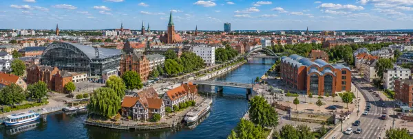 Aerial panoramic view of Bydgoszcz, Poland, with the Brda River, historic buildings, bridges, and city skyline