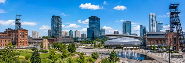 Katowice, Poland with historic industrial buildings, mining structures, modern skyscrapers, and landscaped public spaces