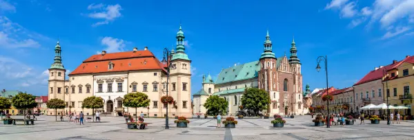 Historic city square and architecture in Kielce, Poland under a bright blue sky