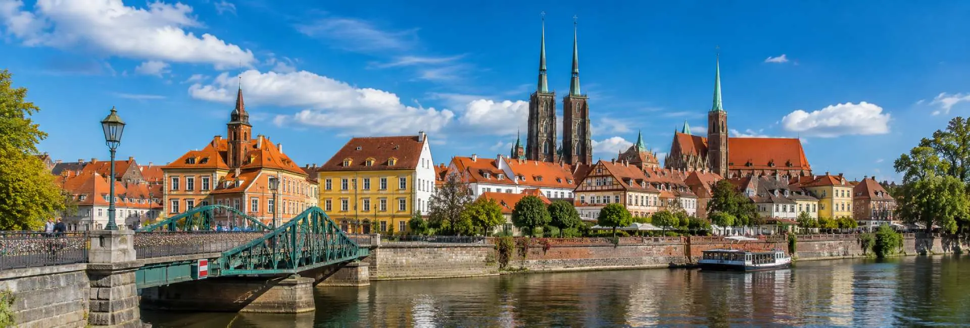 Historic Ostrów Tumski and Gothic cathedral towers along the Oder River in Wrocław, Poland.