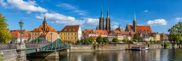 Historic Ostrów Tumski and Gothic cathedral towers along the Oder River in Wrocław, Poland.