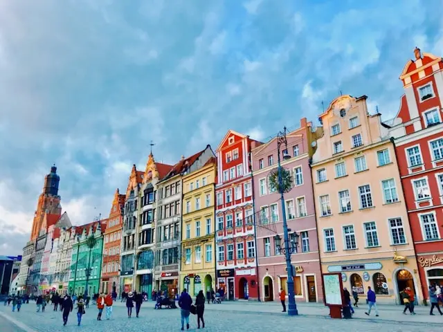 Colorful historic townhouses lining a spacious European market square