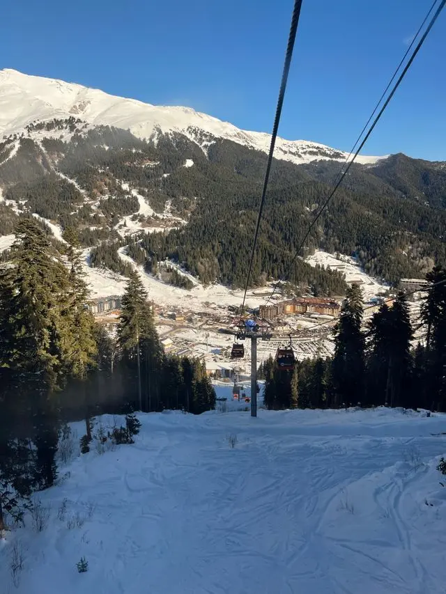 Ski lift descending through a snowy mountain landscape in Zakopane, Poland