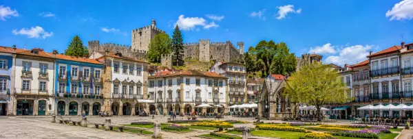Guimarães, Portugal historic square with medieval castle and traditional Portuguese buildings
