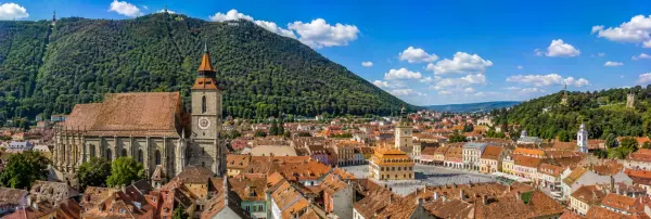 Brașov Old Town with the Black Church, colorful rooftops and Mount Tâmpa in Romania.