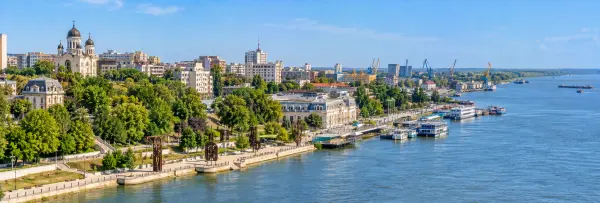 Panoramic view of Galați, Romania, featuring the Danube waterfront, promenade, cathedral, port, and city skyline.