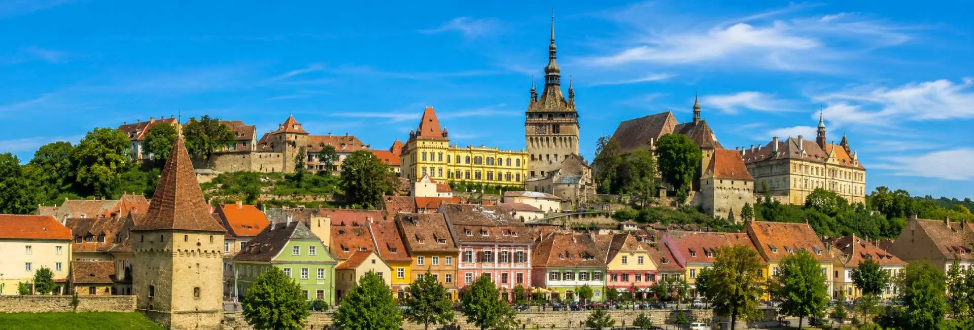 Sighișoara medieval citadel with colorful historic houses and the iconic Clock Tower in Romania