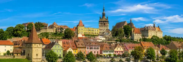 Sighișoara medieval citadel with colorful historic houses and the iconic Clock Tower in Romania