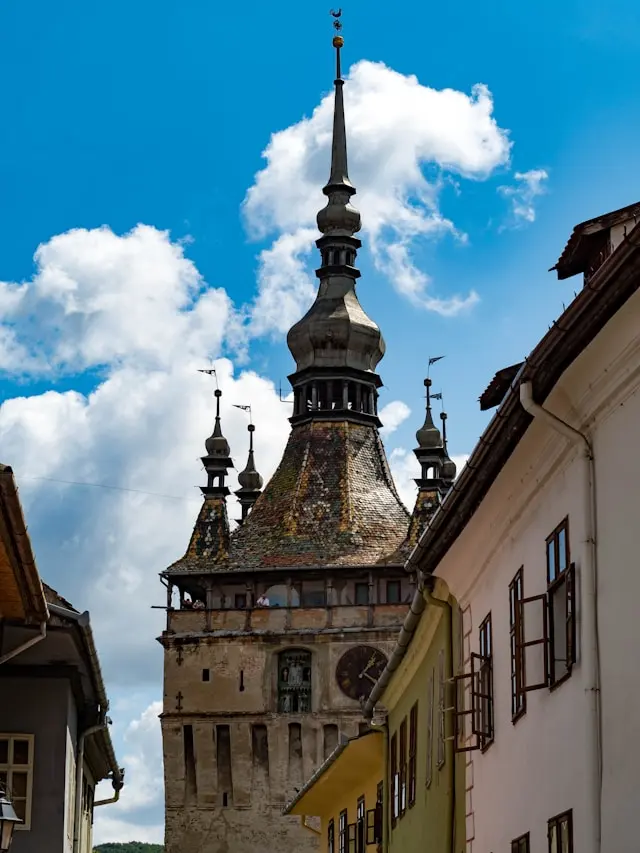 Historic Clock Tower with colorful tiled roof and ornate spires in Sighișoara, Romania