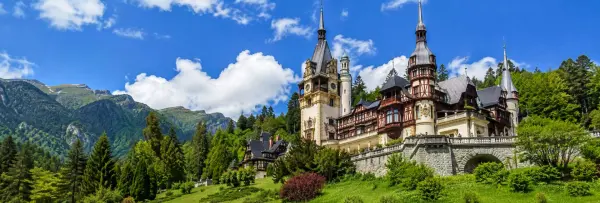 Sinaia, Romania, featuring a historic castle surrounded by the Carpathian Mountains