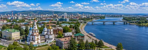 Irkutsk skyline along the Angara River with historic churches, bridges and surrounding hills