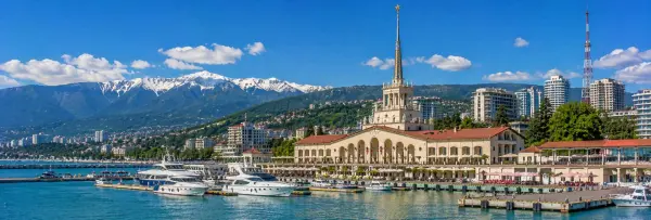 Sochi, Russia with the Black Sea marina, waterfront, mountains and historic railway station