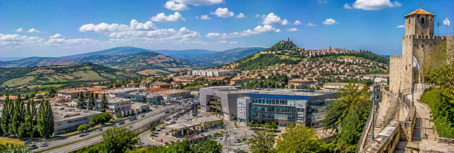 Serravalle in San Marino with historic fortress, terracotta rooftops and green hills