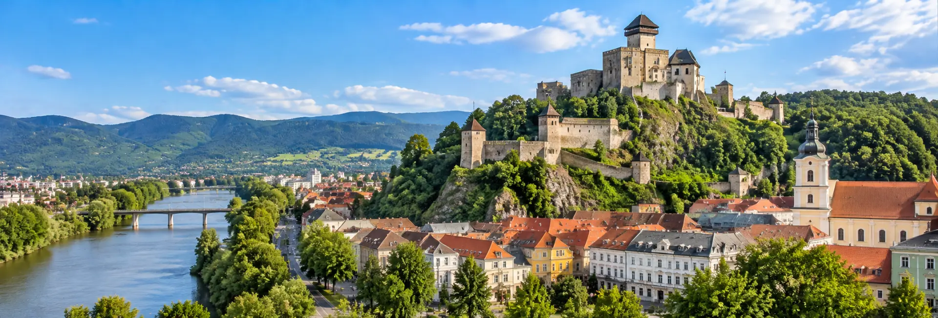 Trenčín, Slovakia, with Trenčín Castle, historic rooftops, Váh River and surrounding mountains