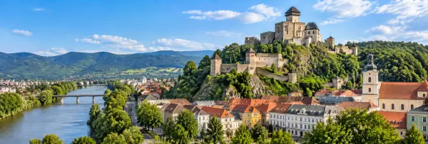 Trenčín, Slovakia, with Trenčín Castle, historic rooftops, Váh River and surrounding mountains