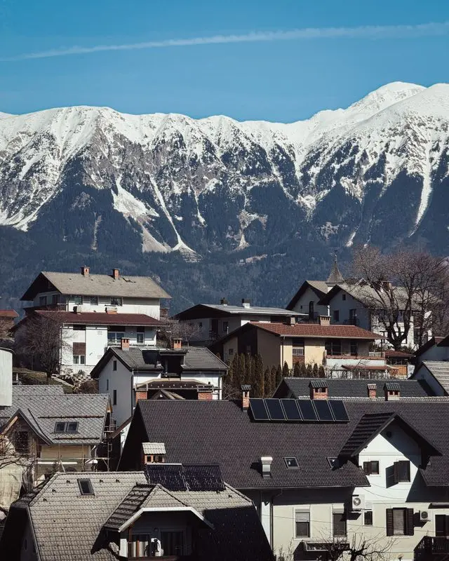 Snow-covered Julian Alps overlooking a village near Bled, Slovenia