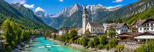 Bovec village beside the turquoise Soča River with the Julian Alps rising behind it in Slovenia.