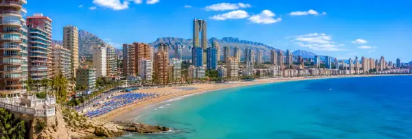 Benidorm, Spain, with its famous skyline, sandy beaches, turquoise Mediterranean Sea, and mountain backdrop