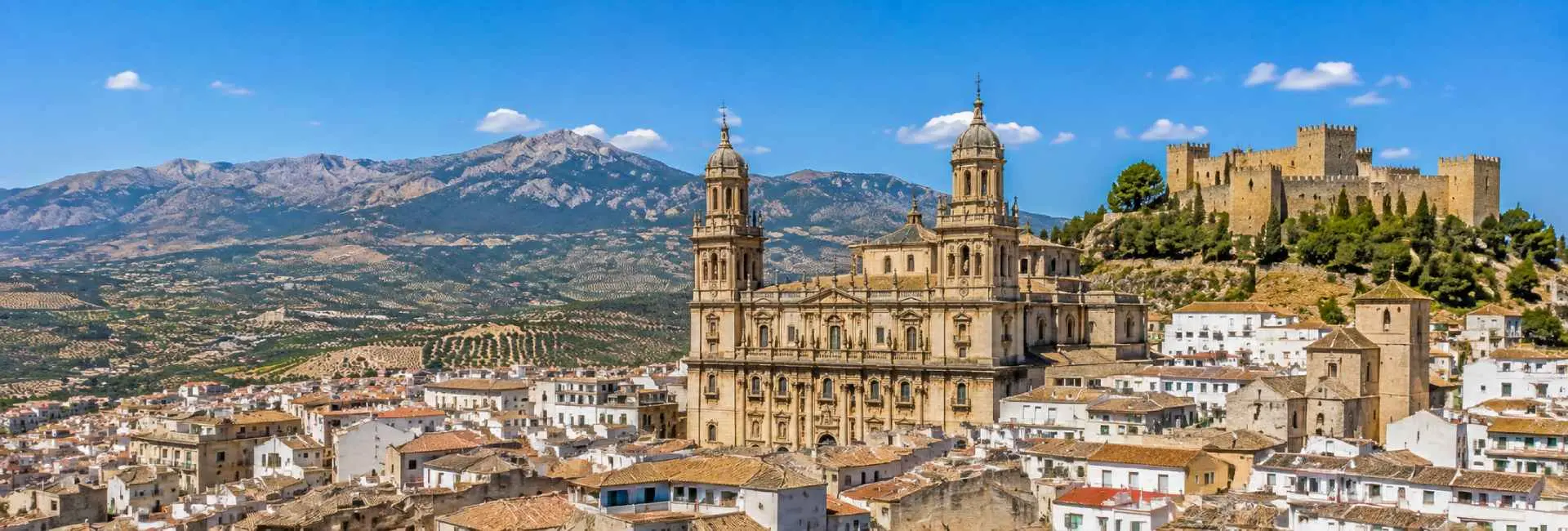Panoramic view of Jaén, Spain, with its cathedral, Santa Catalina Castle, olive groves and mountain backdrop