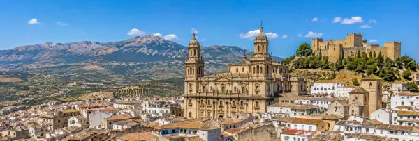 Panoramic view of Jaén, Spain, with its cathedral, Santa Catalina Castle, olive groves and mountain backdrop