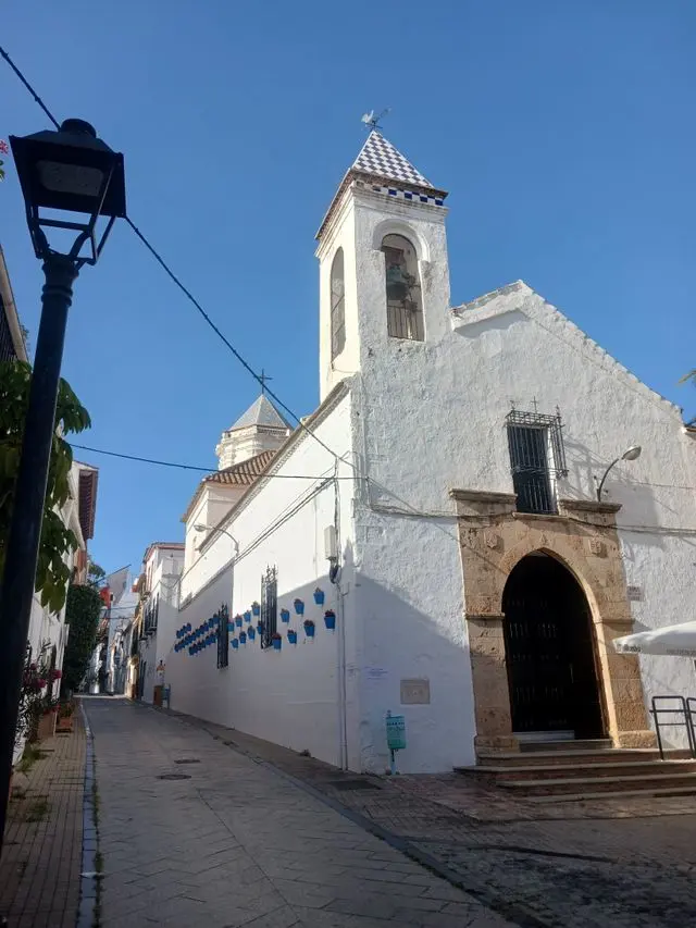 Historic whitewashed church and narrow street in Marbella Old Town, Spain