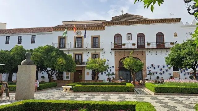 Plaza de los Naranjos with orange trees and historic buildings in Marbella, Spain